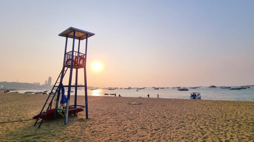 Sun setting behind a lifeguard tower on Pattaya Beach